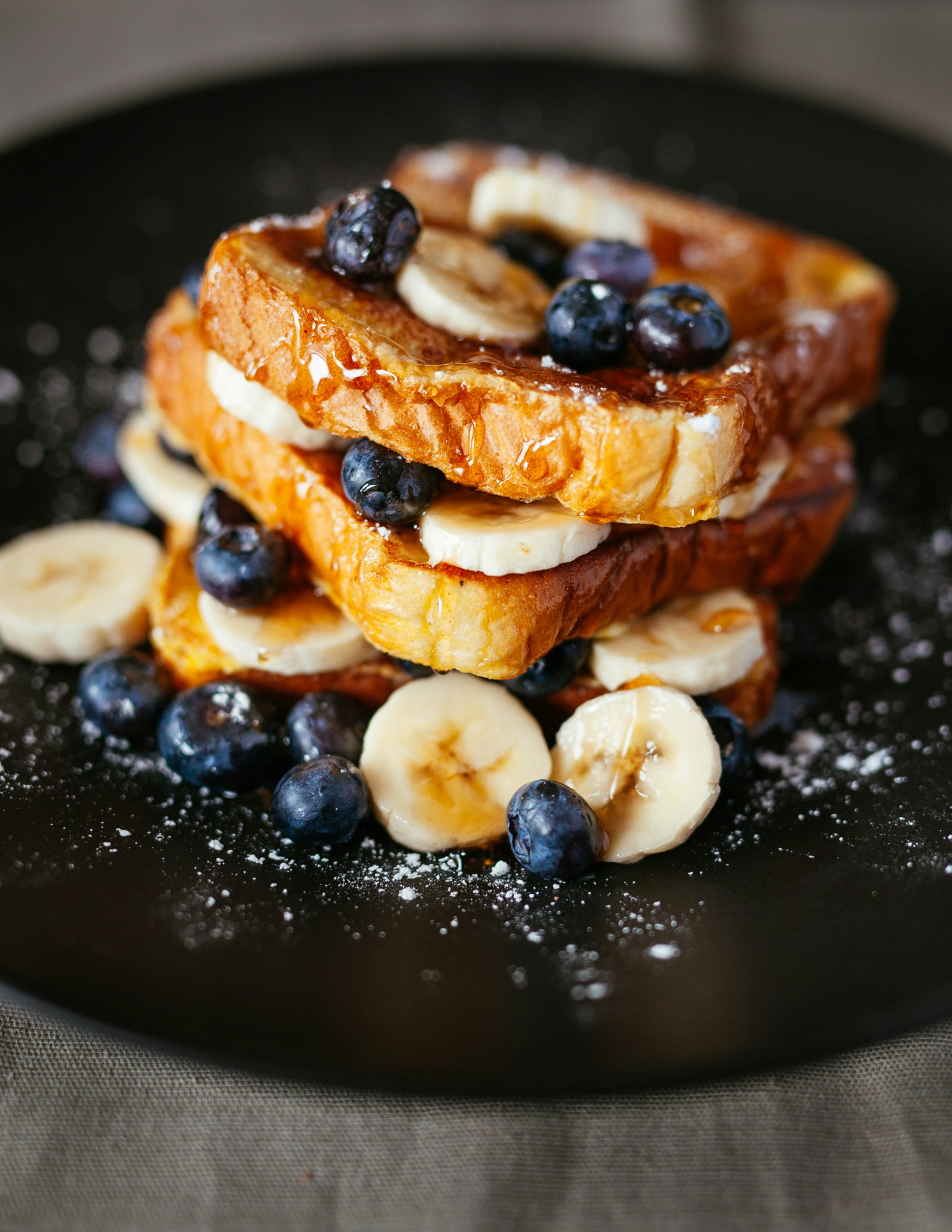 French Toast with sweet syrup and fresh bananas and blueberries.